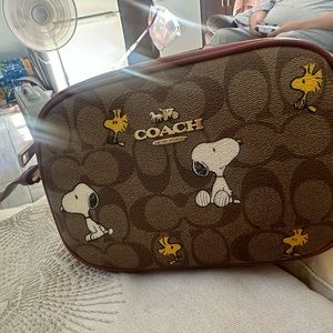 Brand new coach purse comes with limited edition peanuts charm